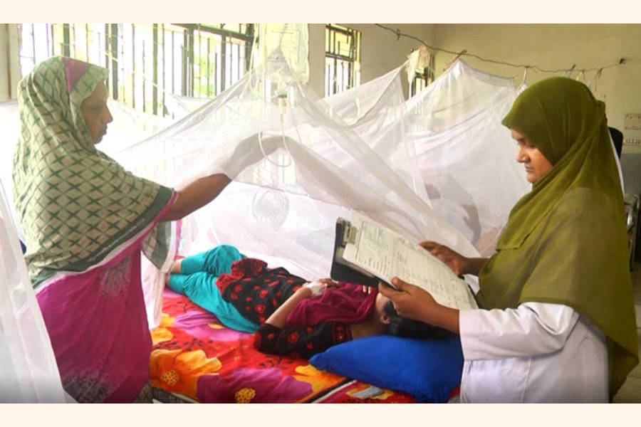 A doctor at Rajshahi Medical College and Hospital checking the reports of a dengue-affected patient on Sunday — FE Photo