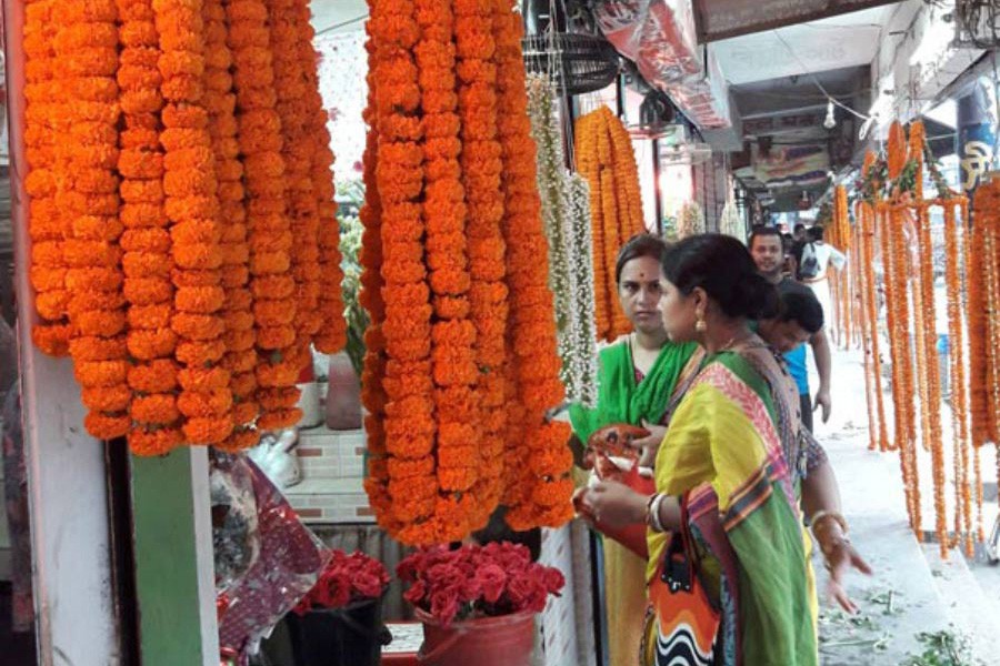 Buyers purchasing flowers at a shop on the Victoria Road Flower Market in Tangail town — FE Photo