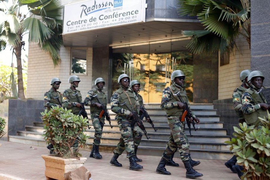 FILE- In this Saturday, Nov. 21, 2015 file photo, soldiers from the presidential guard patrol outside the Radisson Blu hotel in Bamako, Mali, after it was attacked by Islamic extremists armed with guns and grenades - AP Photo / Jerome Delay, File