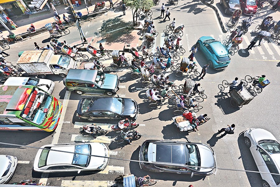 Traffic rules continued to be violated on the second day of enforcement of Road Transport Act, 2018. The photograph of different vehicles blocking pedestrians’ movement through the zebra crossing was taken from Shantinagar in the city on Saturday — FE photo