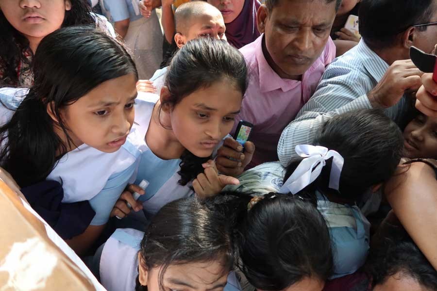 Tension is writ large on the faces of these students of Viqarunnisa Noon School and College in Dhaka as they look at the notice board for JSC and JDC results — FE/Files