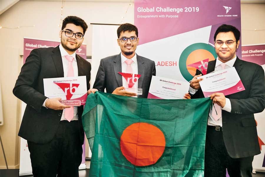 Winners of RB Global Challenge 2019 —Team Who Dis from North South University— (left to right) Syed Towhid Bashar, Mahdi Mohammad Mehrab and Mohammad Tahsin Nawaz holding the champion trophy and the flag of Bangladesh