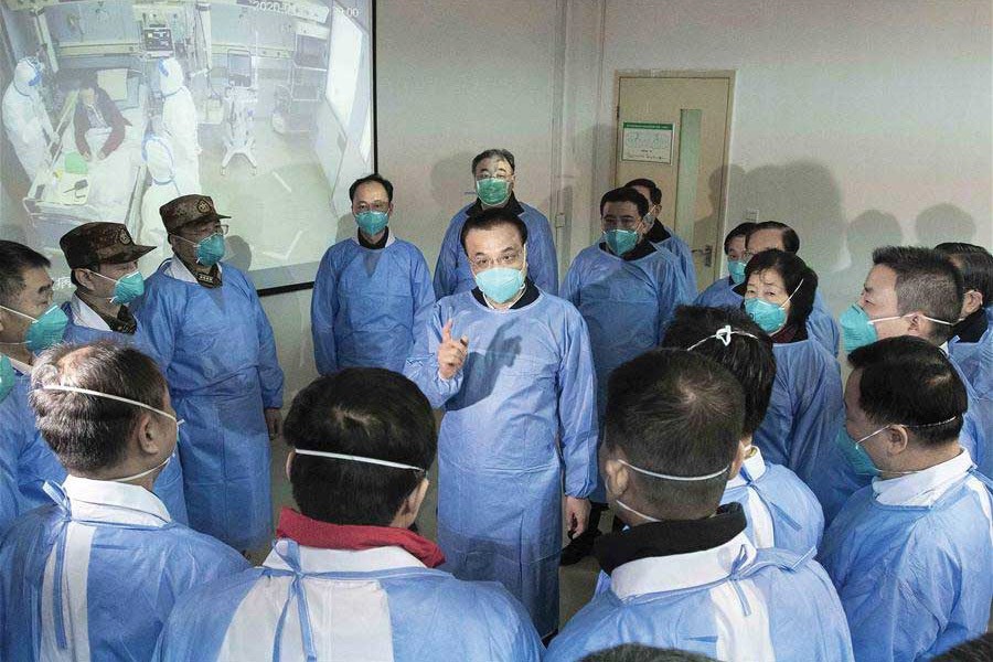 Entrusted by President Xi Jinping, general secretary of the Communist Party of China (CPC) Central Committee, Premier Li Keqiang (clad in a blue protective suit and mask) visited Wuhan to inspect and direct the efforts for the prevention and control of the novel coronavirus outbreak. —Photo: Xinhua
