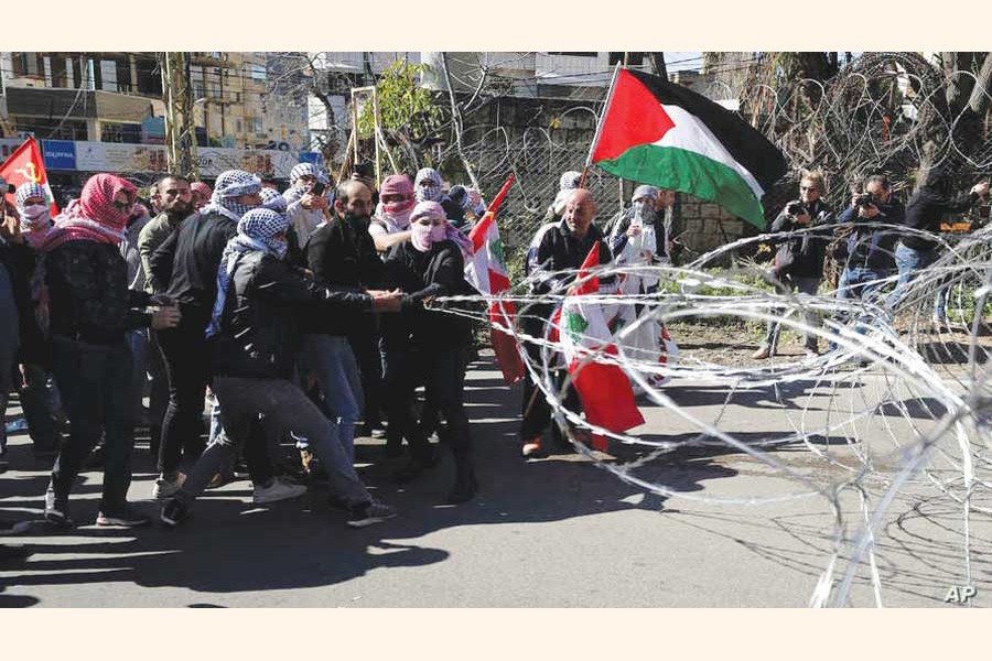 Protesters try to remove barbed wires that block a road leading to the U.S. Embassy during a protest is held against the proposed peace deal for the Middle East by President Donald Trump, in Aukar, east of Beirut, Lebanon on February 02, 2020. —Photo: AP