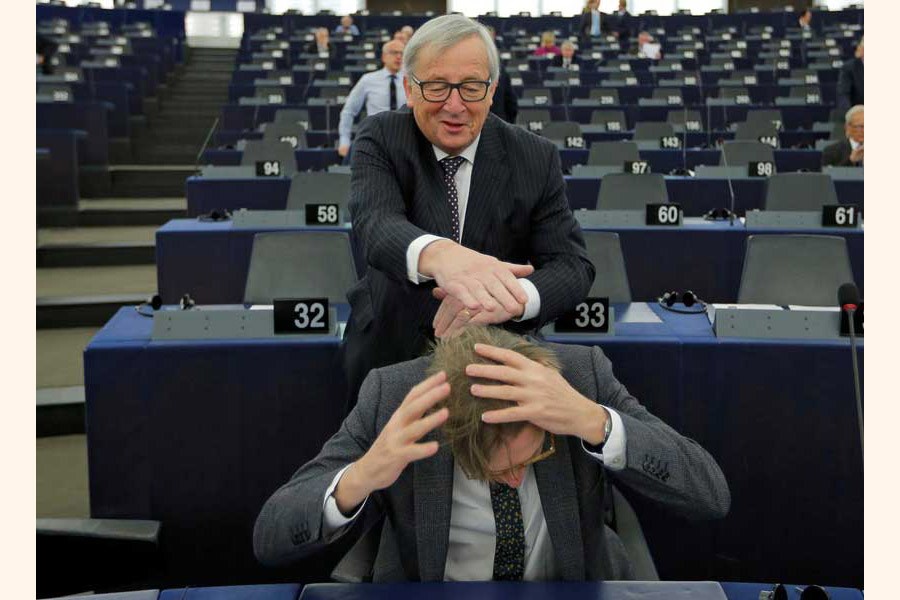 European Commission President Jean-Claude Juncker jokes with European Union's chief Brexit negotiator Guy Verhofstadt ahead of a debate on the Future of Europe at the European Parliament in Strasbourg, France on February 06, 2018. —Reuters