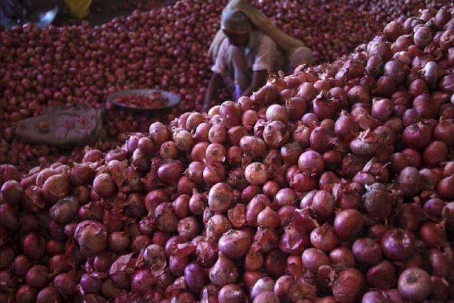 A worker sorts onions at a wholesale vegetable market in Chandigarh, India, July 24, 2015. Reuters/Files
