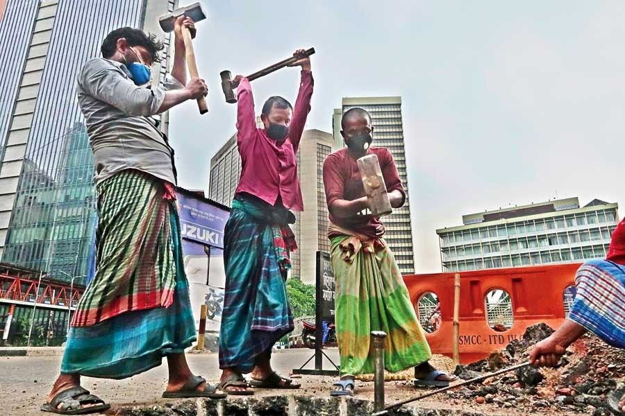 Workers toiling at the Motijheel site of the Dhaka Metro Rail project in the city on Thursday ahead of the May Day today — FE photo by Shafiqul Alam