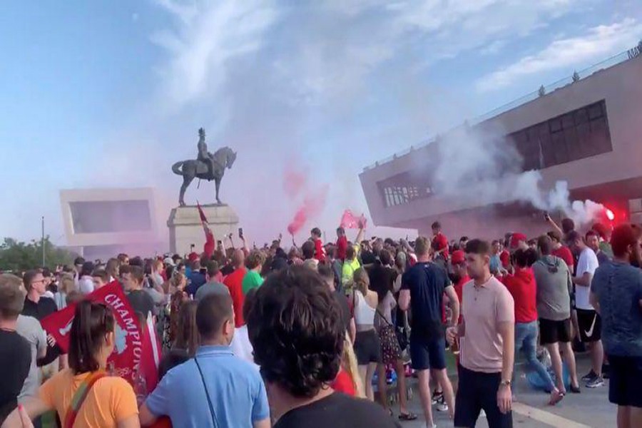 Soccer fans gather at Liverpool's Pier Head, during the novel coronavirus pandemic, celebrating Liverpool FC winning the Premier League title, in Britain June 26, 2020 in this still image taken from social media video. Content filmed June 26, 2020. Paul Kallee Grover via REUTERS