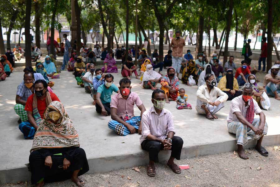 People waiting for relief supplies provided by local community in Dhaka a few months ago —Al Jazeera Photo