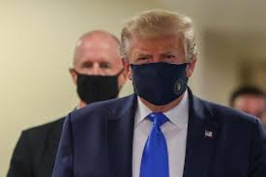 President Donald Trump, who has avoided wearing a mask in public even as the coronavirus pandemic spread, donned one on July 11 at a military medical facility outside Washington where he was to meet with wounded soldiers and front-line health-care workers. -- Reuters photo