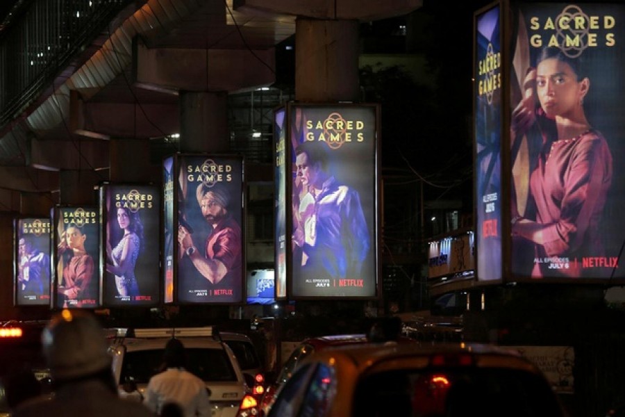 Traffic moves on a road past hoardings of Netflix television series "Sacred Games" in Mumbai, India, July 11, 2018. REUTERS/Francis Mascarenhas