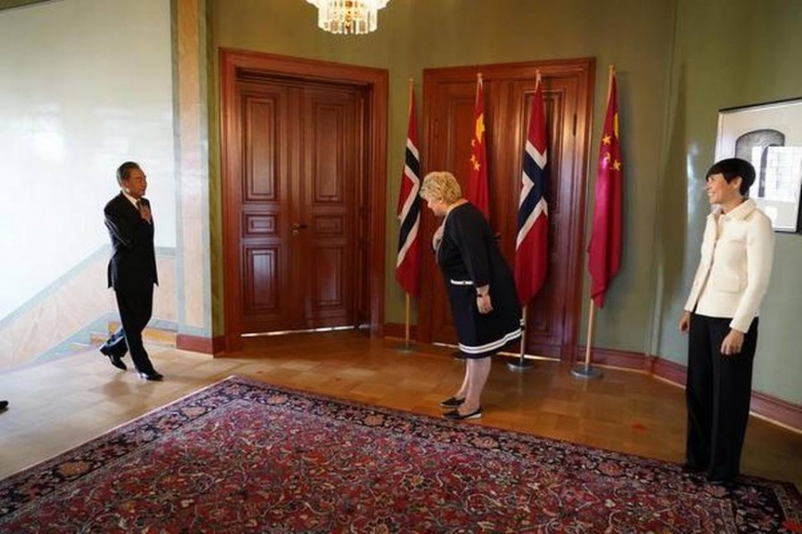 Norwegian Prime Minister Erna Solberg and Foreign Minister Ine Eriksen Soreide greet Chinese Foreign Minister Wang Yi during his short courtesy visit to Norway, in Oslo, on Thursday. REUTERS - via REUTERS