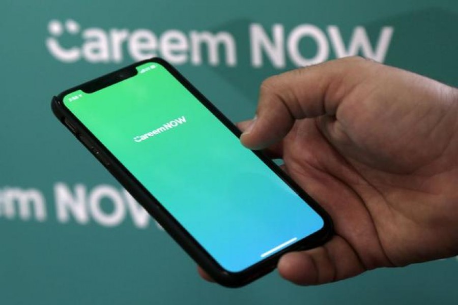 Careem CEO Mudassir Sheikha shows the logo of the company's delivery service Careen NOW on his mobile at the company headquarters in Dubai, UAE December 13, 2018. REUTERS/Satish Kumar