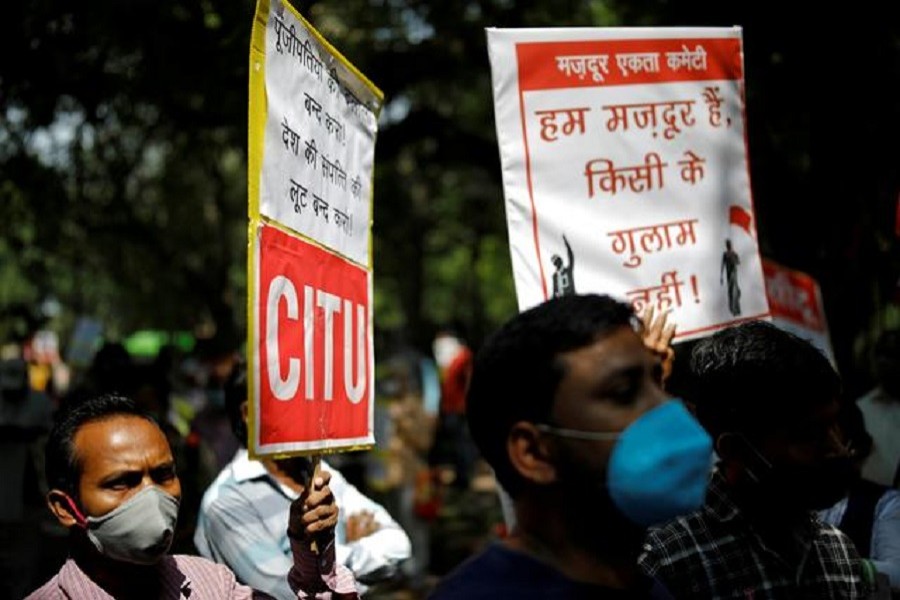 People hold placards as they attend a protest organised by various trade unions against labour law changes and the disinvestment and privatisation of public sector enterprises, in New Delhi, September 23, 2020 — Reuters/Files