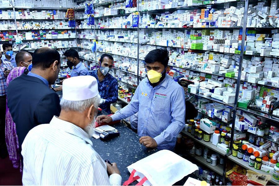 Customers buy face masks at a pharmacy in Dhaka — Xinhua Photo