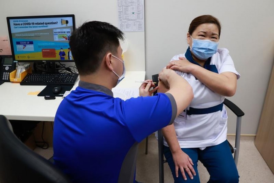 A healthcare worker receiving a dose of coronavirus disease (COVID-19) vaccine at the National Centre for Infectious Diseases (NCID) in Singapore on December 30, 2020, –Reuters file photo