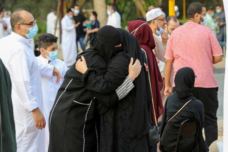 Saudi women greet each other after performing Eid prayers on the first day of Eid-ul-Fitr, amid the coronavirus disease (COVID-19) pandemic, outside the King Abdulaziz Mosque, in Riyadh, Saudi Arabia, May 13, 2021. REUTERS
