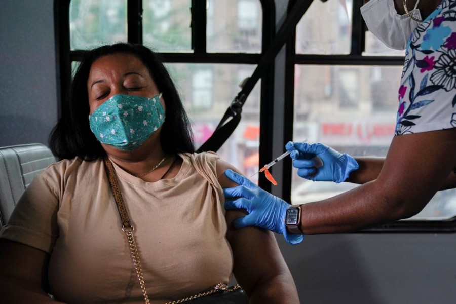 A person receives a dose of the Pfizer-BioNTech vaccine for the coronavirus disease (COVID-19), at a mobile inoculation site in the Bronx borough of New York City, New York, US, August 18, 2021. REUTERS/David 'Dee' Delgado/File Photo