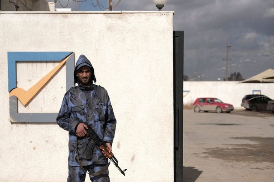 A security officer stands in front of the High National Election Commission building in Benghazi, Libya December 16, 2021. REUTERS/Esam Omran Al-Fetori/File Photo Libya's parliament said Friday's planned presidential election would not go ahead, leaving the internationally backed peace process in chaos and the fate of the interim government in doubt. The electoral commission proposed pushing back the voting date by a month, confirming a delay that had been widely expected amid ongoing disputes over the rules, including the eligibility of several divisive major candidates. Disagreements showed the limitations of a winner-takes-all presidential vote involving candidates viewed as unacceptable in large parts of the country including the son of Muammar Gaddafi and a military leader who assaulted Tripoli. At stake is a peace process that had been seen as the best hope in years of bringing an end to the decade of chaos and violence that has engulfed Libya since a NATO-backed uprising ousted Gaddafi in 2011. Very large numbers of Libyans had already registered for voting cards for the election in what politicians on all sides in Libya have said is a sign of strong popular desire for a vote. However, with mobilisations in Tripoli and other western areas by armed groups, the collapse of the electoral process risks aggravating local disputes and triggering a new round of fighting. Disputes over the path forward could also undo the wider UN-backed peace process between Libya's main eastern and western camps that have maintained a ceasefire since last year. Some figures in the east have warned of a new breakaway government that would return Libya to the division between warring administrations that lasted from the last election in 2014 until the installation of the current interim government. Factions, candidates and foreign powers have been talking behind the scenes about whether an election can still take place with a short delay or whether a longer postponement is necessary to reach agreement on the legal basis of the vote. UN special adviser Stephanie Williams said on social media she had been meeting members of the political forum that set the electoral process in train last year and reiterated the need for "free, fair and credible elections". Meanwhile, the status of the interim government that was installed in March as part of the same peace process is also at risk, with the eastern-based parliament having withdrawn confidence from it in September. DISPUTES The electoral committee's statement on Wednesday added that the government's mandate would expire on Friday. However, other main factions and political institutions may stick with the government, which is also recognised by the United Nations. The election was originally called through a UN-backed roadmap that envisaged simultaneous parliamentary and presidential elections on Dec 24 - Libya's national day. However, there was no agreement on the constitutional basis for the election or on the rules among the country's fragmented political institutions. In September the speaker of parliament Aguila Saleh, himself a presidential candidate, issued a law that his critics said was not properly passed through the chamber, deviated from the roadmap and was crafted to benefit himself and his allies. That law, which split the presidential election from a later parliamentary one, formed the basis of the electoral process, although powerful factions and leading candidates rejected it. With little agreement on the rules, or on who would enforce them or adjudicate disputes, the entry of highly divisive candidates into the presidential race triggered the collapse of the process. Electoral commission head Emad Sayeh said in a statement that the process had run into trouble because the rules were not adequate to handle appeals and disputes over eligibility. The three most prominent candidates, eastern commander Khalifa Haftar, Saif al-Islam Gaddafi and interim Prime Minister Abdulhamid al-Dbeibah, were also the three most divisive. Haftar was unacceptable to many in western Libya after his 2019-20 assault on Tripoli that smashed parts of the capital. Gaddafi was convicted of war crimes by a Tripoli court and is detested by many of those who fought in the 2011 revolt. Dbeibah had promised when he was installed as premier that he would not run in an election and his continued work as prime minister in the run-up to the vote led many of his rivals to say he had an unfair advantage.
