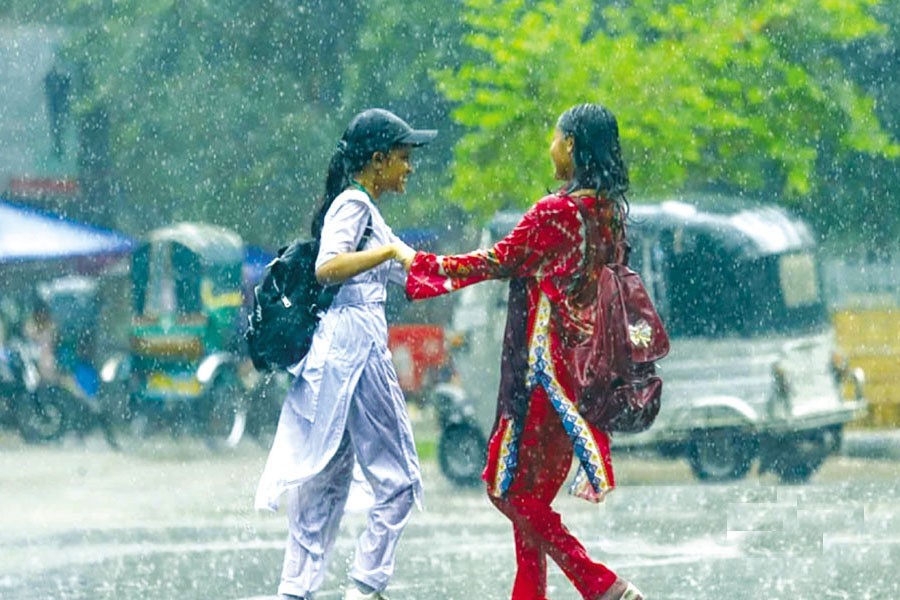 Students enjoy the rain in Dhaka. —bdnews24.com Photo